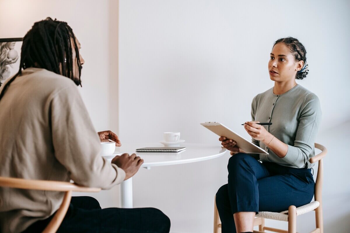 A young man being asked common HR job interview questions during an interview